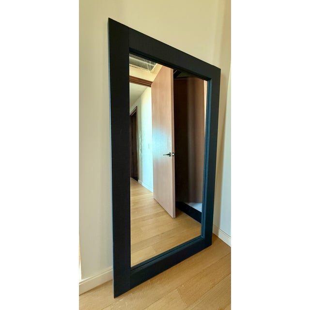 Black textured frame, large floorstanding mirror, leans stably against wall, no hardware needed