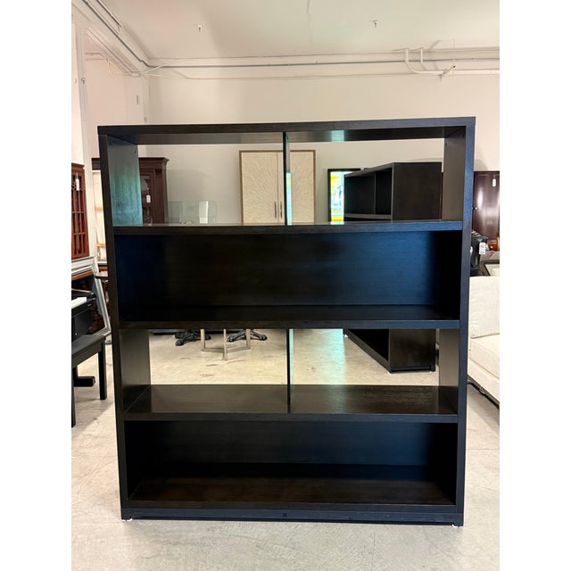 Design Plus Gallery presents the Evans Book Rack from Penta Living. This contemporary shelving unit combines a sturdy...