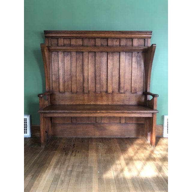 Hall settle from the Arts & Crafts period attributed to George Henry Walton (Scottish, 1867–1933). Quarter sawn oak....