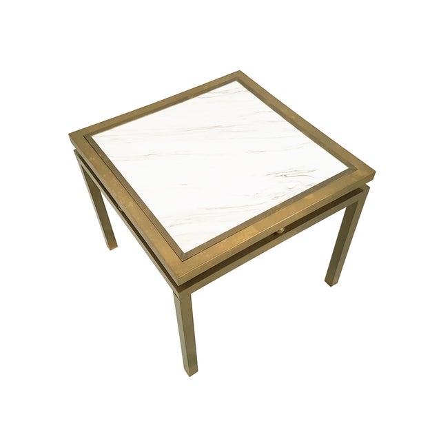 This elegant coffee table was produced in Italy around the 1970s. It is made from a brass structure with a white marble...
