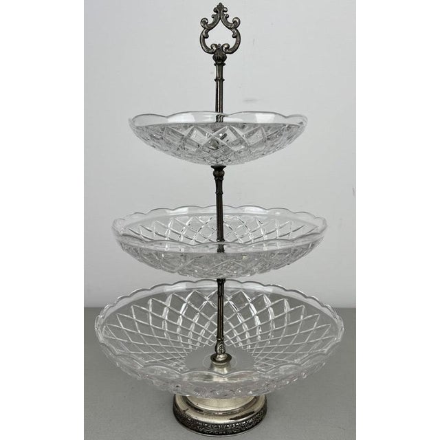 A decorative Vintage French crystal cut bomboniere featuring three graduated tiers with patterned clear crystal bowls and...