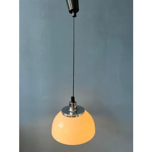 Classic Guzzini 'Faro' acrylic glass pendant lamp. The white shade is made of acrylic glass and produces a magnificent...