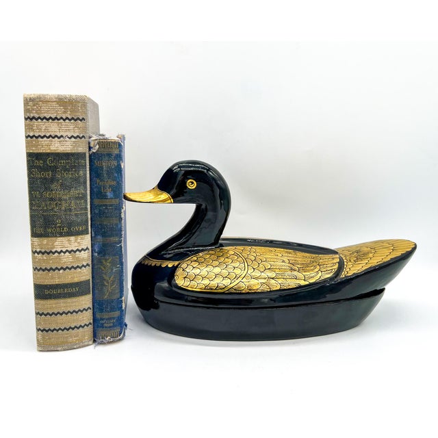 Sleek, bold, and undeniably charming, this oversized black lacquer duck box adds an eye-catching accent to any surface....
