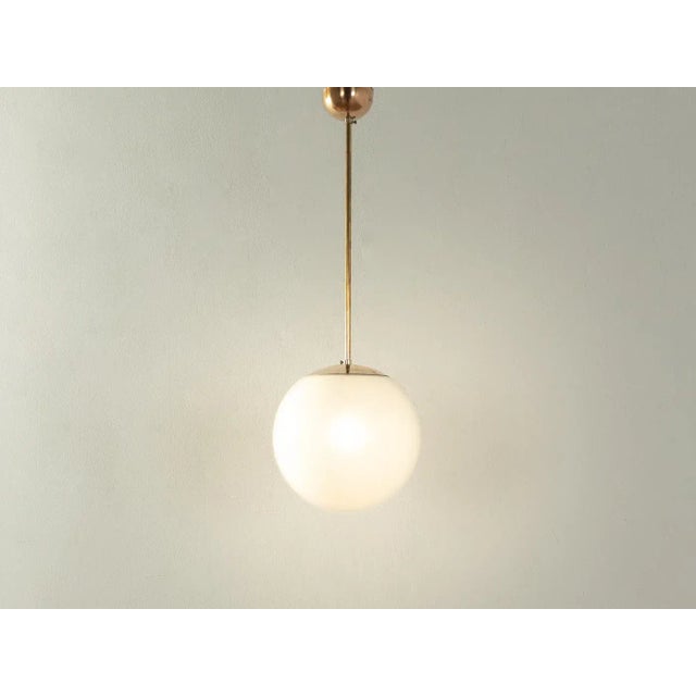 Classic ball ceiling lamp from the Bauhaus era from the 1950s. Lampshade made of opal glass with hanging metal...