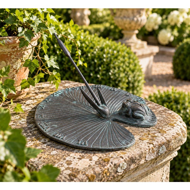 A classic iron garden sundial inspired by traditional English estate landscapes featuring two frogs on a lily pad. Pieces...