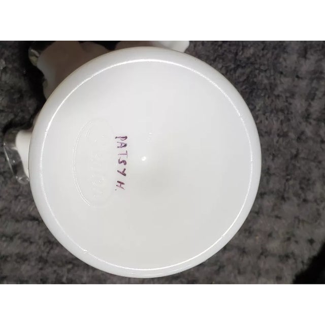 Showcasing classic mid-century elegance, this Fenton Milk Glass Silver Crest trumpet vase is a timeless collectible....