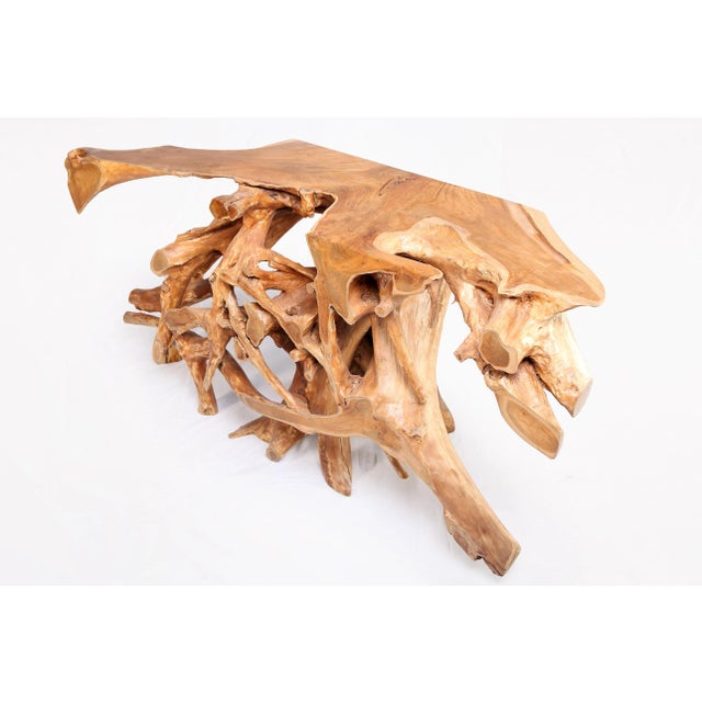 Inspired by the beauty of natural root form, this organic teak console table is handcrafted from one piece of salvaged...