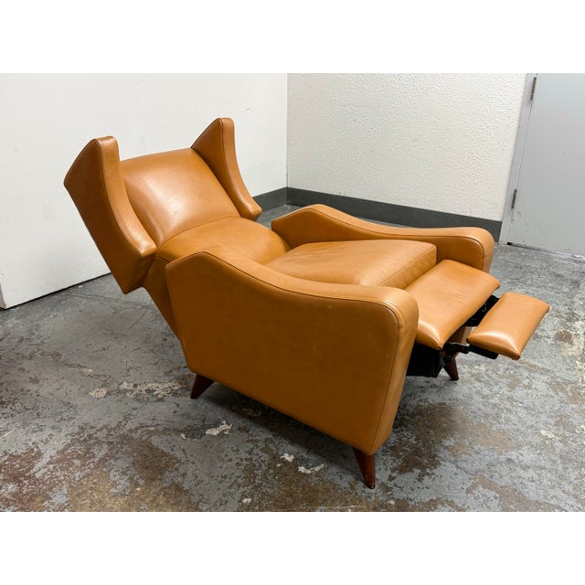 Design Plus Gallery presents a Juno Leather Recliner from Room & Board. This upholstered recliner has a high wingback...