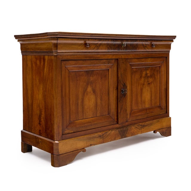 Buffet or credenza in the Louis Philippe style from France. It is made of solid wood construction, primarily walnut. It...