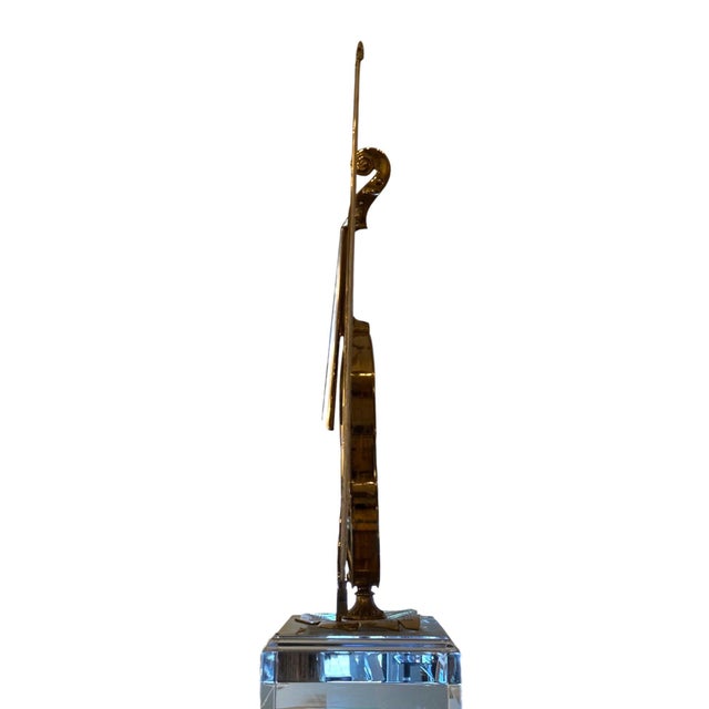 A striking Italian polished bronze violin sculpture, dating to the 1960s, conceived as a highly decorative interpretation...