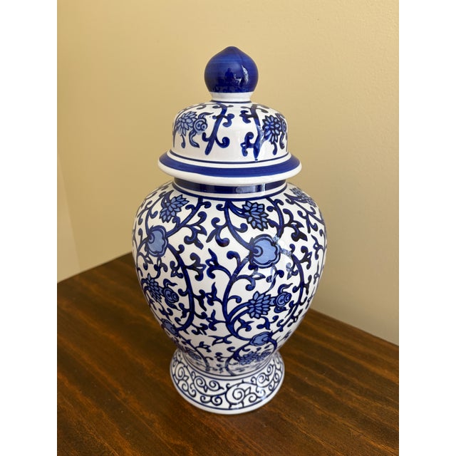 A beautiful Chinoiserie blue and white porcelain covered ginger jar China, Late 20th Century Measures: 7ʺW × 7ʺD × 13ʺH....