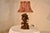 Wonderful cast lamp in the Black Forest style of wood carving. The lamp depicts a tree in the background with a standing...