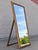 An elegant vintage full-length floor mirror featuring an ornate giltwood frame with carved foliate detailing and a warm,...