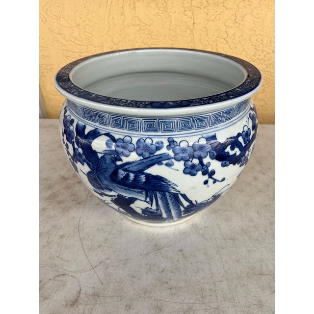 The is a vintage Japanese blue and white porcelain planter or jardinière. It features an intricate, hand-painted design of...