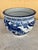 The is a vintage Japanese blue and white porcelain planter or jardinière. It features an intricate, hand-painted design of...