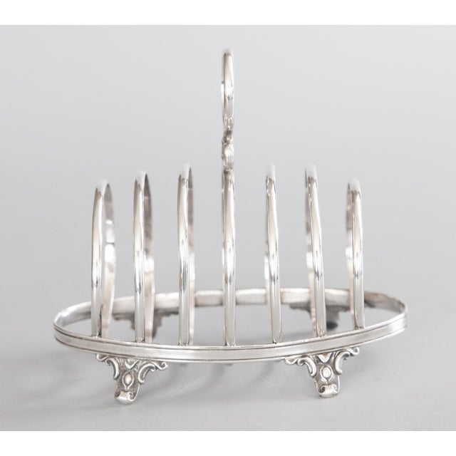 A fine antique Art Deco English silverplate six slot toast rack. No maker's mark. This stunning toast rack has a sleek and...