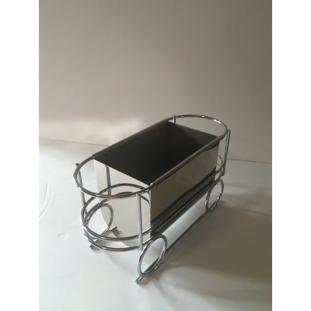 Fun chrome caboose shaped accessory. May be used as a wine bottle trolly to avoid rings marks on the dining table......