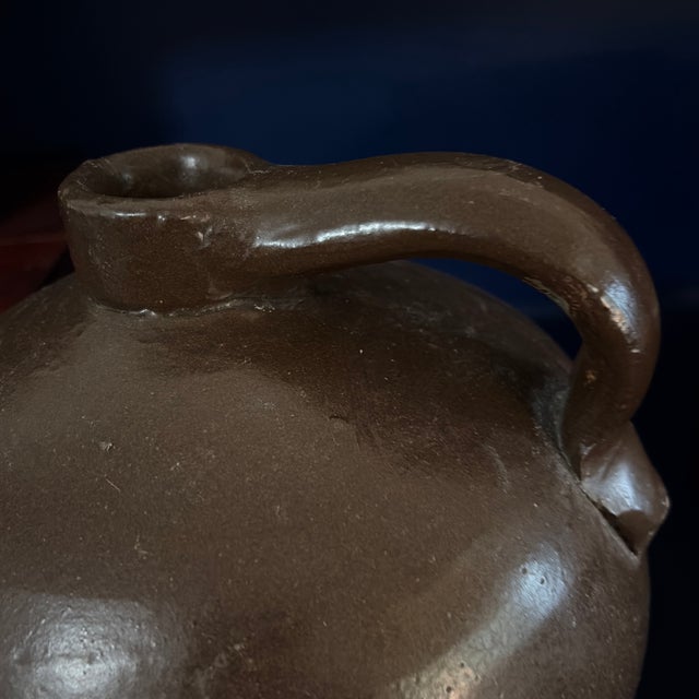 brown salt glaze Crock Jug with some normal imperfections Applied handle. The crock was usually held with one hand slung...