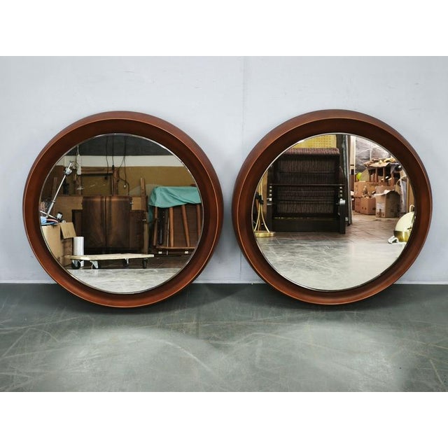 A striking pair of Italian Space Age illuminated round mirrors dating from the 1970s. The mirrors feature sculptural...