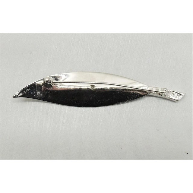 This is part of Chairish’s Costume Jewelry assortment. Late 1950s ribbed rhodium plated with clear baguette rhinestone...