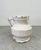 Antique hand-thrown jug in a soft creamy white glaze that is elegantly refined in its simplicity, highlighting the skill...