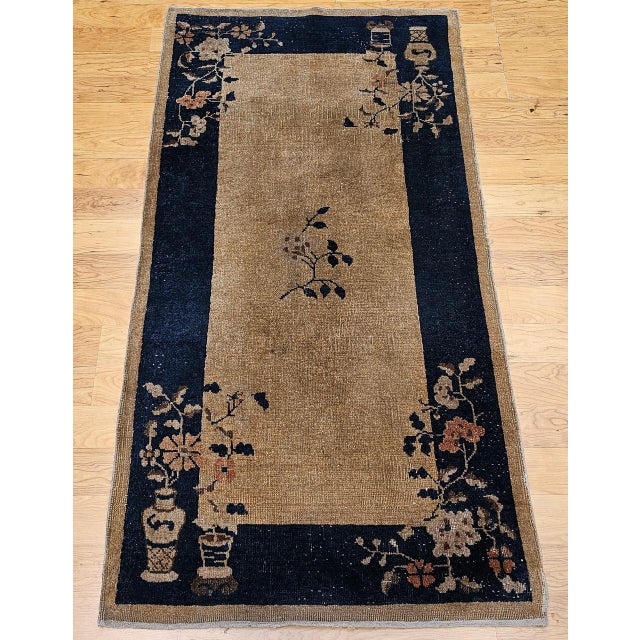 This vintage Art Deco Chinese area rug from the early 20th century presents a timeless and tranquil composition of refined...