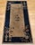 This vintage Art Deco Chinese area rug from the early 20th century presents a timeless and tranquil composition of refined...