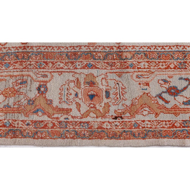 An antique Persian Sultanabad rug dating back to circa 1900 features allover palmettes, florals, and vines enclosed with...