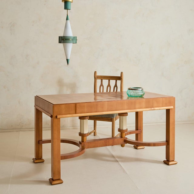 A French desk from the 1940s, defined by its hand-cut and inlaid parquetry top. The surface is composed in a geometric...