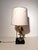 A striking vintage table lamp featuring a beautifully detailed eagle with outstretched wings, perched on a sphere and...