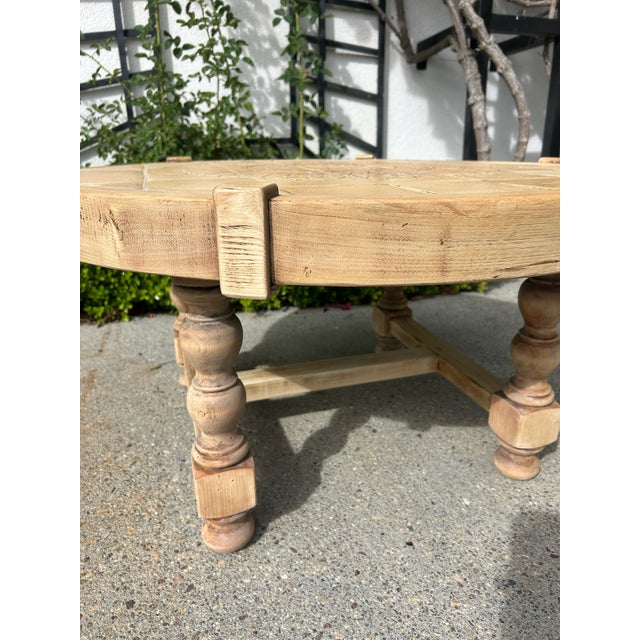 Vintage round coffee table with carved wood base and inset tile top. Circular top features a geometric patterned tile...
