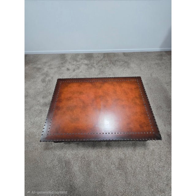 Authentic Polo Ralph Lauren trunk-style coffee table featuring a rich brown finish, extensive decorative nailhead...