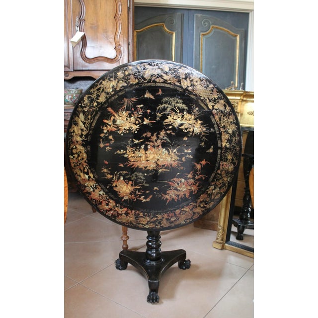 A fine early Chinese lacquer tilt top table decorated with stunning painted and gilded vignettes. There are all manner of...