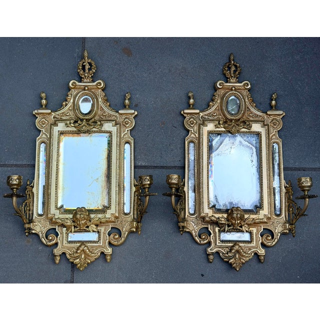An exceptional, highly decorative pair of antique French Renaissance Revival cast brass girandole mirror sconces, dating...
