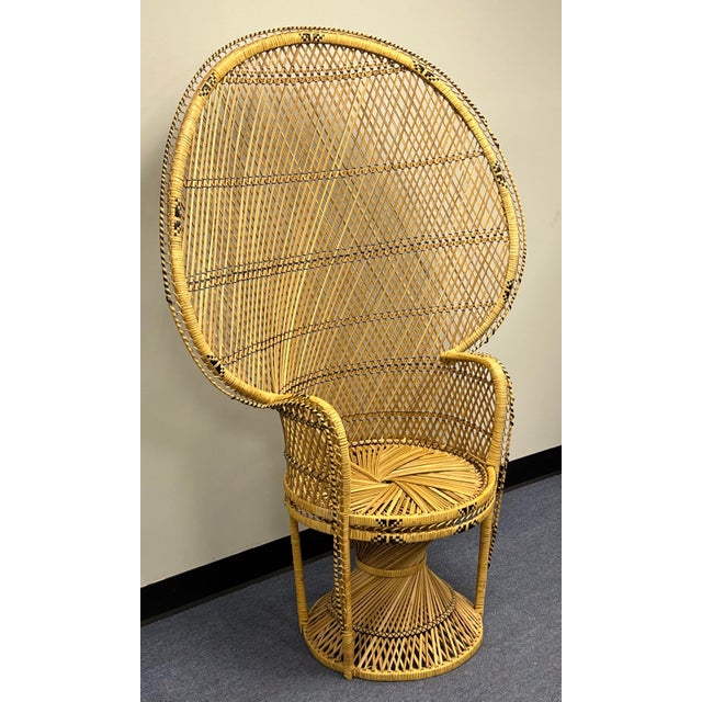 This iconic vintage wicker and rattan peacock chair features an expansive, intricately woven flared high back and a sturdy...