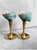 A striking pair of vintage solid brass candlesticks topped with natural green turbo shells. The warm polished brass...