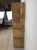 This vintage boho chic shelving unit features rattan construction with original finish, four shelves, and arched top.