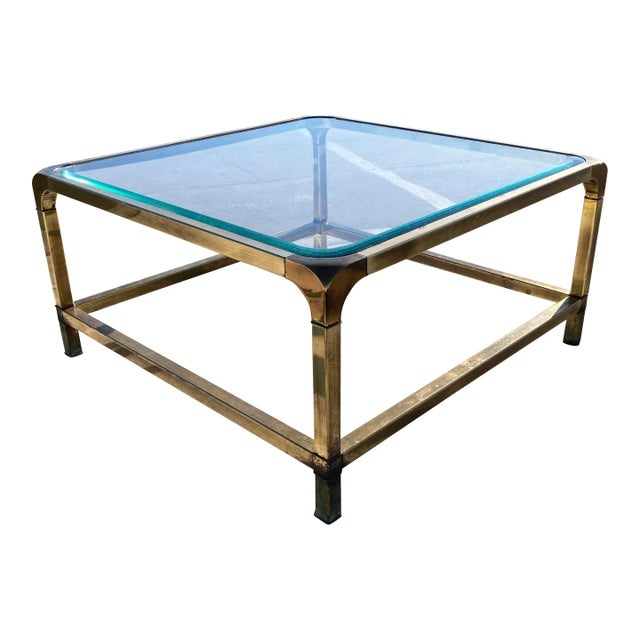 Vintage solid brass tubular rounded corner base coffee table, with signature beveled glass inset top, manufactured in...