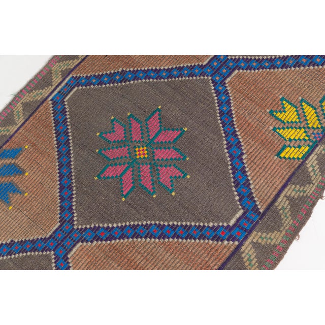 This is a vintage Turkish Oushak rug from the Mid 20th Century. The piece was hand-knotted.