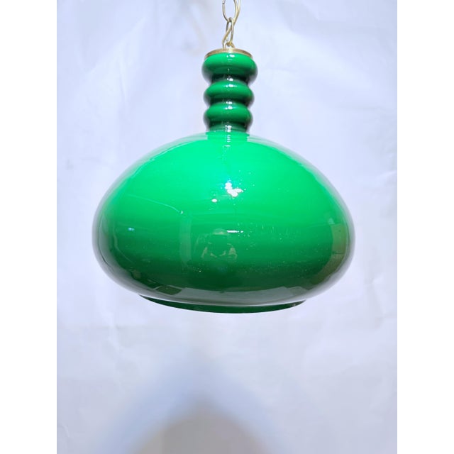 Mid-Century French green glass shade pendant. It has 1 socket that use a 75W candelabra base lightbulbs or equivalent LED...