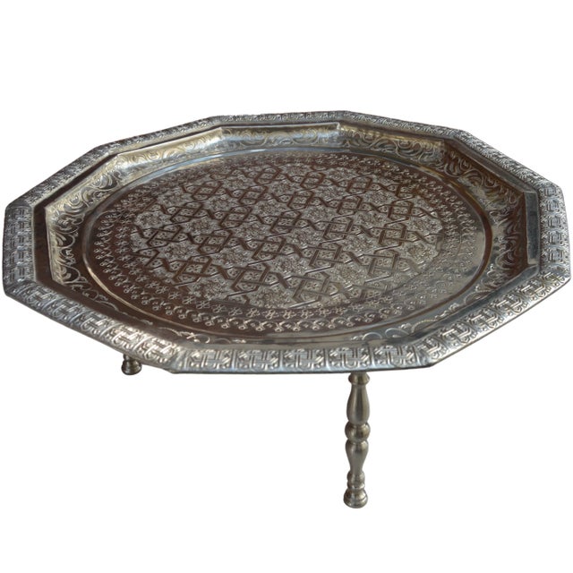 Vintage highly crafted, hand-hammered and engraved Moroccan footed tray. Constructed of solid silver nickel with ornate...