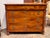 19th century French Empire walnut commode with a frieze drawer over three long dovetailed drawers, flanked by columns and...