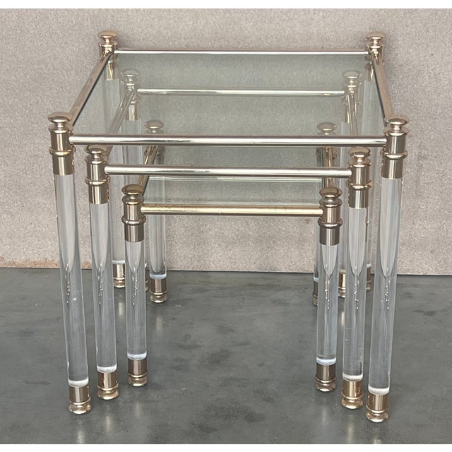 These Mid-Century Modern nesting tables embody the 1970s. They are comprised of a Lucite frame joined by golf connectors...