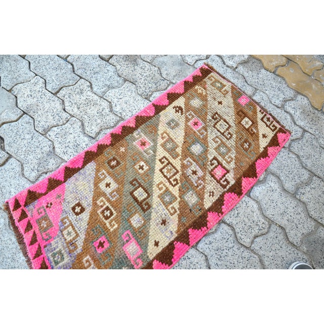 This is a vintage Turkish Oushak rug from the 1960s. The piece was hand-knotted.