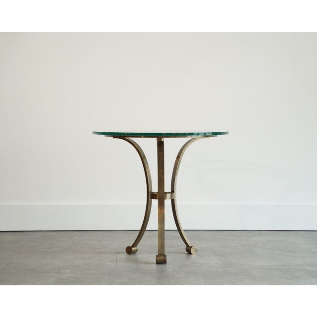 Elegant 1940s French occasional table executed in solid bronze, showcasing a refined Streamline Moderne silhouette. The...