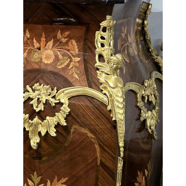 A true masterpiece of French craftsmanship, this elegant Louis XV bombe chest combines timeless sophistication with...