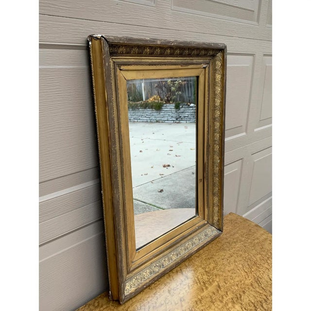 A gorgeous antique Victorian carved gilt wood framed mirror. USA, Circa Late 19th Century Measures: 22.5"W x 2.25"D x...