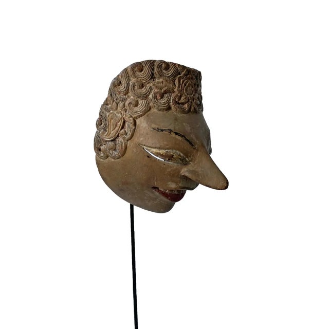 This early 20th century ‘Wayang topeng’ mask was used in Javanese masked dance performances. This mask features a beige...