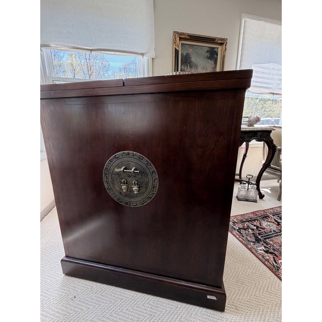 Beautiful flip-top bar cabinet with marble serving counter. This cabinet is truly gorgeous and offers a pull-out wine...