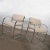 Handsome pair of modern chrome accent or dining armchairs with an off-white gaberdine-like fabric upholstery. They are in...